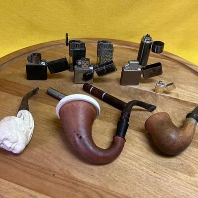 A collection of vintage smoking pipes and lighters