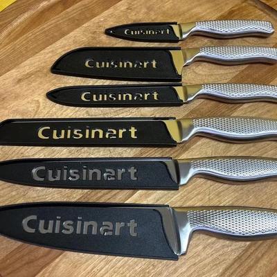 A modern Cuisinart six-piece knife set with black blade covers and silver handles
