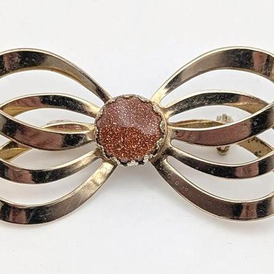 Sale Photo Thumbnail #114: Vintage Gold Tone Bow Brooch with Goldstone Cabochon