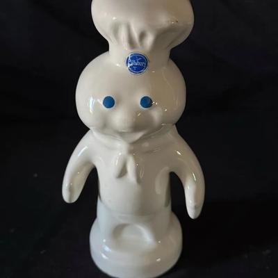 411: Classic vintage Pillsbury Doughboy ceramic coin bank, standing approximately 7 inches tall.
