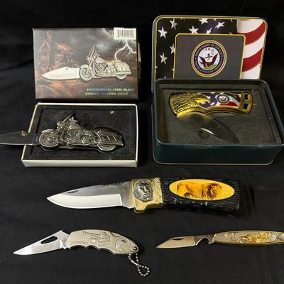 304: Patriotic and Novelty Folding Knife Lot with Eagle, Military, and Motorcycle Designs        