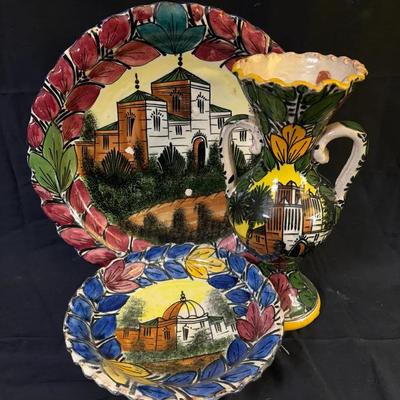 334: Hand-Painted Majolica-Style Ceramic Plates and Vase with Architectural Motifs  This decorative 