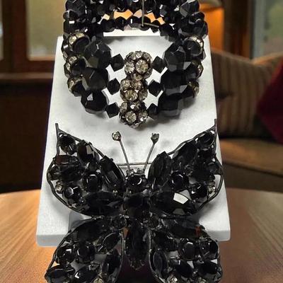 Black rhinestone butterfly brooch complementing expansion cuff