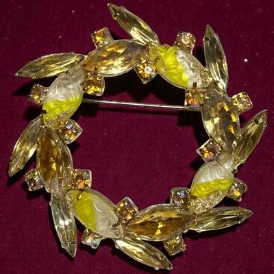 Circle wreath design brooch in yellow tones