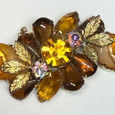 Rhinestone brooch featuring amber brown, and aurora borealis