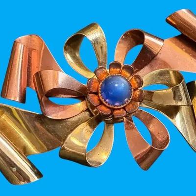 Copper and brass colored bow pin