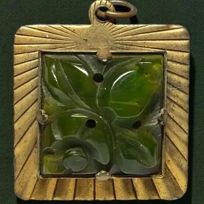 Carved pierced, green bakelite pendant