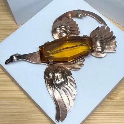 Sterling bird brooch with large center stone
