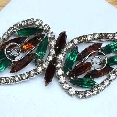 Rhinestone brooch with a silver tone setting and multi colored stones
