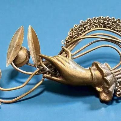 Art nouveau brooch hand holding flowers