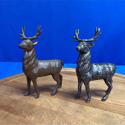 A pair of vintage cast metal deer coin banks.