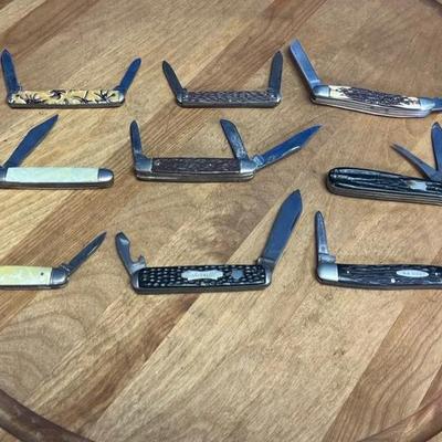 A collection of nine vintage folding pocket knives with varied handles