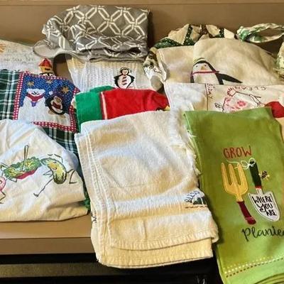 Assortment of Kitchen Oven Mitts, Towels, and Apron