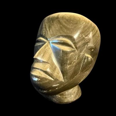 Carved golden obsidian mesoamerican bust