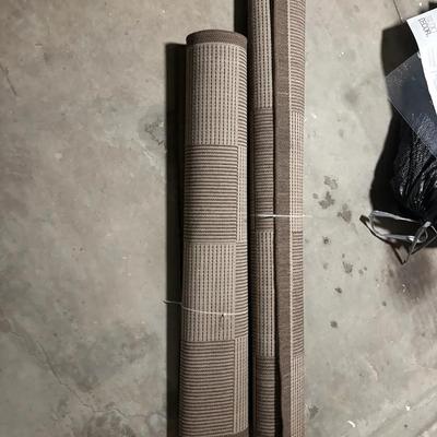 Pair of Brown and Tan Woven Area Rugs Rolled