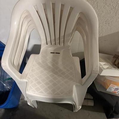 Stacked White Plastic Patio Chairs With Matching Table