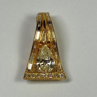 Stunning 14k enhancer pendant with pear diamond set in 14k yellow gold framed by channel set diamond baguettes and brilliant round...
