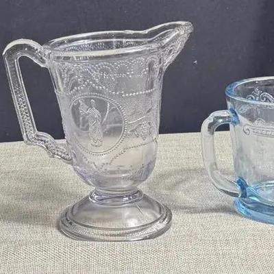 Various Glass Items (1880 Small Pitcher, Vtg Fire King Mug, Furniture Coasters, And Red Trays)