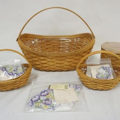 Sale Photo Thumbnail #82: 1082	ASSORTED LONGABERGER BASKETS INCLUDING LARGE 2006 CROCUS BASKET WITH PROTECTOR, 2 SMALL CROCUS BASKETS WITH PROTECTORS AND HANDKERCHEIFS, 2004 MOTHERS DAY WITH PROTECTORS, LINER AND LID, LARGEST APPROXIMATELY 14 IN X 10 IN X 12 IN H
