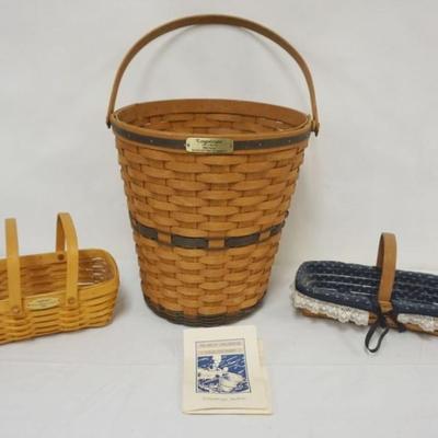 Sale Photo Thumbnail #92: 1092	ASSORTED LONGABERGER BASKETS INCLUDING 1989 J.W. BANKERS WASTE BASKET WITH LINER, 1999 WOVEN MEMORIES BASKET WITH PROTECTOR AND SIGNED BY 6 FAMILY MEMBERS AND 1988 CRACKER BASKET WITH LINER AND PROTECTOR, LARGEST APPROXIMATELY 12 1/2 IN DIAMETER X 13