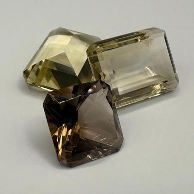 Three Loose Emerald Cut Gemstones Including Smoky Quartz