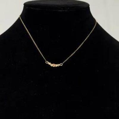12k gold-tone chain necklace featuring a curved bar pendant with small, multi-colored beads or gemst