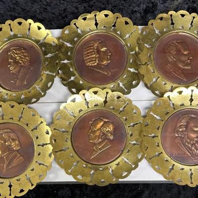 set of six vintage brass and copper wall plates featuring famous composers