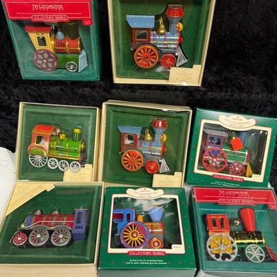 collection of Hallmark Keepsake Tin Locomotive Series Christmas ornaments from various years
