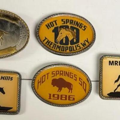 collection of vintage rodeo and event belt buckles