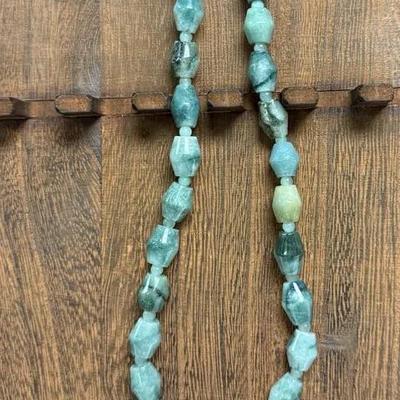necklace featuring large, irregular-shaped aquamarine gemstones in varying shades