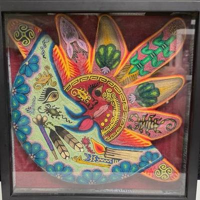 handmade Huichol yarn painting depicting a sun and moon eclipse