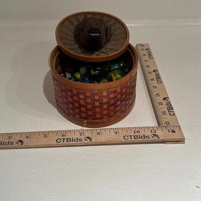 Woven Basket with Animal-Themed Lid Containing Assorted Glass Marbles
