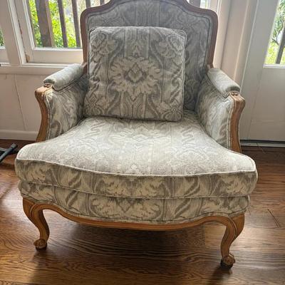 Carved Wood Armchair with Patterned Upholstery and Matching Pillow