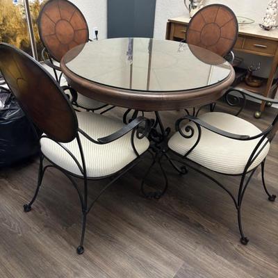 Leather/wrought iron table and four chairs. 