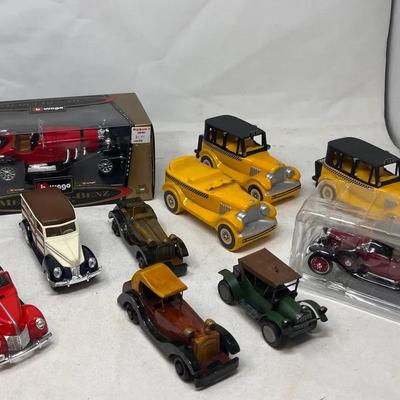 Collection of die cast metal cars includes Burago Mercedes SSK, 1940 Ford woody wagon