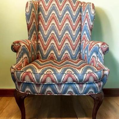 Herein Queen Anne-style wingback chair with flame-stitch upholstery. 