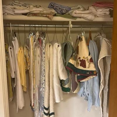 Large Lot Of Various Size Table Cloths, Two Small Rugs, Several Blankets.