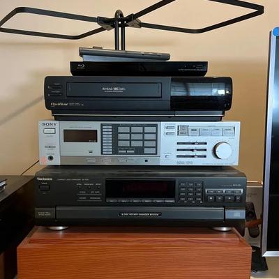 Sony STRVX450 Audio/Video Control, Technics SLPD8 Disc/CD Player, VHS Player on Wood Pedestal