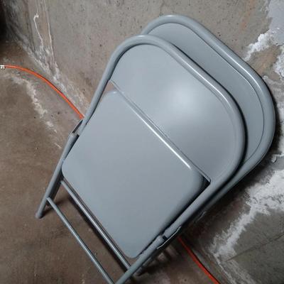 Two gray folding chairs