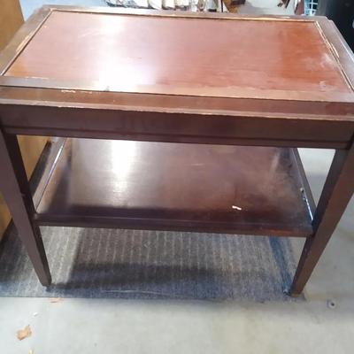Small vintage dark wood side table on wheels