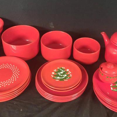A Table Of Red And Christmas Serving Items