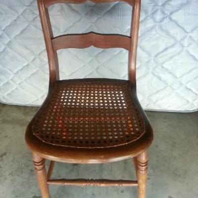 dark wood chair with a wicker seat.
