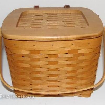 2001 Longaberger picnic basket with double handles, wood and weaved lid, leather hinges, and plastic liner.