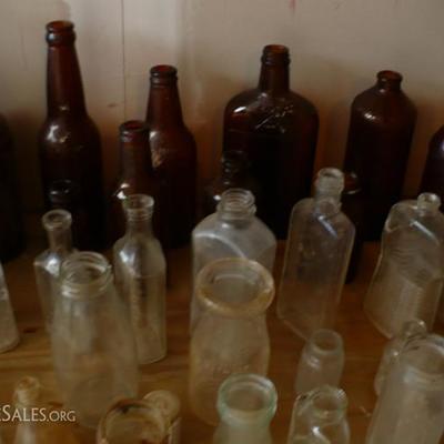 Dozens of old collectible bottles, clear, brown, blue