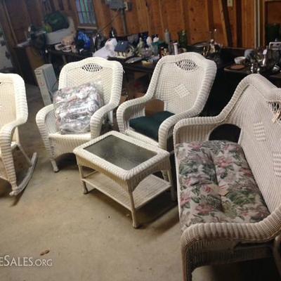 Beautiful wicker set. Rocker, 2 chairs and glass and wicker coffee table.