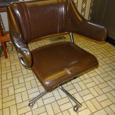 A leather upholstered swivel chair