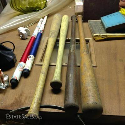 Assorted bats and pool cues
