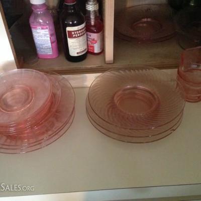 Part of a collection of rose Depression glass plates and cups