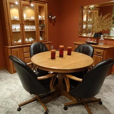 Solid Oak dining table with four chairs and two leaved. All the items in this condo are in excellent condition. 