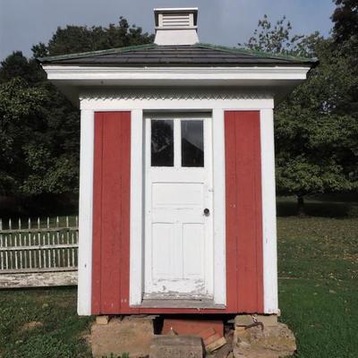 Early Outhouse with double seat, window, and vent.